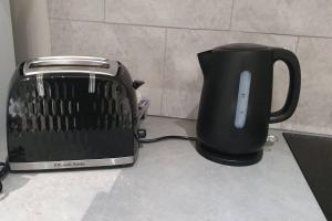 a toaster sitting next to a toaster on a counter at Studio flat in lovely Alexandra Palace London in London