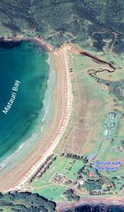an aerial view of a beach and the ocean at Beach House Matauri Bay in Matauri Bay