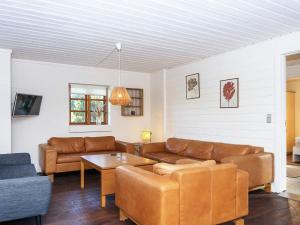 a living room with a couch and a table at 7 person holiday home in Grenaa in Grenå
