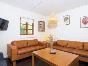 a living room with a couch and a table at 7 person holiday home in Grenaa in Grenå
