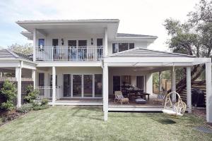 a large white house with a porch and a patio at Verandah Retreat - A Beach House by the sea in Cowes