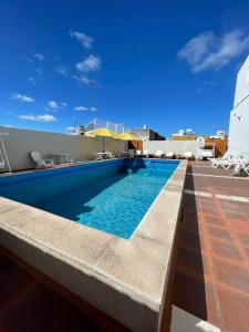 a swimming pool on the roof of a building at Hotel Dora in Termas de Río Hondo