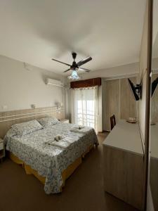a bedroom with a bed and a ceiling fan at Hotel Dora in Termas de Río Hondo
