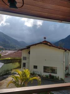 a view of a building from a window at Casa Martim de Sá in Caraguatatuba