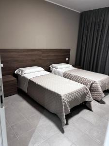 Postel nebo postele na pokoji v ubytování Bella Napoli albergo Chiari