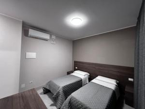 Postel nebo postele na pokoji v ubytování Bella Napoli albergo Chiari