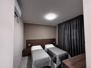 Postel nebo postele na pokoji v ubytování Bella Napoli albergo Chiari