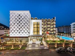 a large building with a pool in front of it at Elite World Marmaris - Adult Only in Marmaris