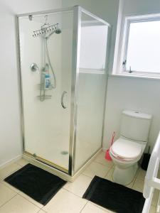 a bathroom with a shower and a toilet at A private Large master room with en-suite in Auckland