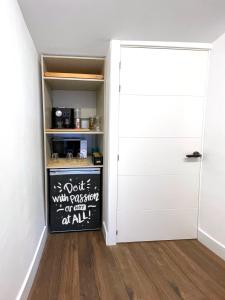 a closet with a chalkboard next to a door at Luxury Pintoreria Atico in Vitoria-Gasteiz