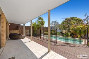 an outdoor deck with a swimming pool in a house at Kingscliff Ocean Vista in Kingscliff