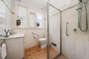 a bathroom with a shower and a toilet and a sink at Pine Lodge in Blackheath +21 photos