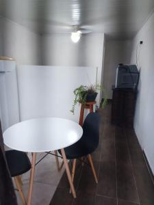 a white table and chairs in a room at Pousada 12 Ilhas in Pontal do Paraná