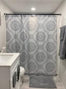 a bathroom with a shower curtain and a toilet at key Deer Retreat/direct gulf access/hot tub in Big Pine Key