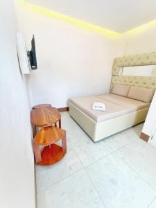 a small room with a bed and a stool at GTC Pension House in Santa Rita