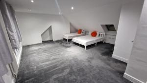 a white room with two beds and orange pillows at Comfort Sleep - Rooms with shared facilities in Windsor +27 photos