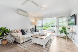 a living room with a couch and a table at Quarterdeck in Noosaville