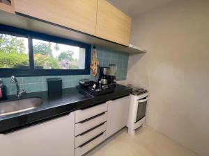 a kitchen with a sink and a counter top at Flat Pingo de Milagres in São Miguel dos Milagres +14 photos
