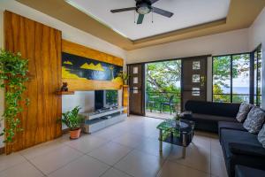 a living room with a couch and a fireplace at Oceanside 2 bedroom house, 100Mbps WiFi in Panglao Island