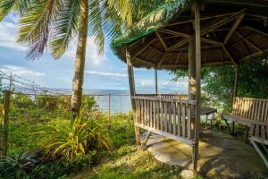 a wooden gazebo with a view of the ocean at Modern studio, by the ocean, 50Mbps WiFi in Panglao