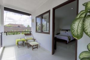 a bedroom with a bed and a table and chairs at Sari Temuku Villa in Seminyak