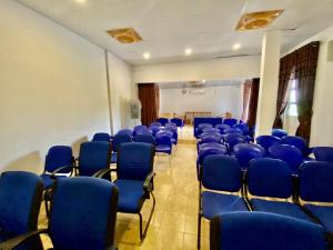 an empty room with blue chairs in a room at Green Villa in Oluvil