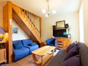 a living room with a couch and a tv at Chalet Duplex à Peyragudes – 3 Chambres, Cheminée, Terrasse, Près des Sentiers et Télécabine - FR-1-695-38 in Germ