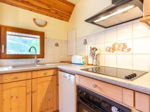 a kitchen with a sink and a stove at Chalet Duplex à Peyragudes – 3 Chambres, Cheminée, Terrasse, Près des Sentiers et Télécabine - FR-1-695-38 in Germ +5 photos