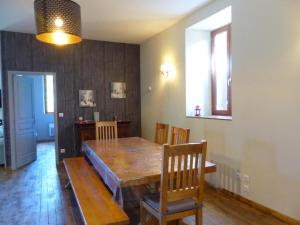 a dining room with a wooden table and chairs at Gîte Chantelle, 3 pièces, 6 personnes - FR-1-489-482 in Chantelle