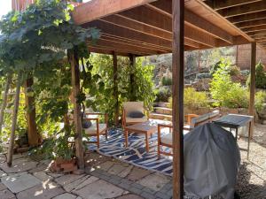 a pergola with a table and chairs in a garden at ATTACHED MOTHER-IN-LAW SUITE Soak in the hot tub, star gaze, enjoy the reservoir, hike, bike, kayak and more - Private floor, entrance, terrace and room and bathroom, not the full house in Fort Collins