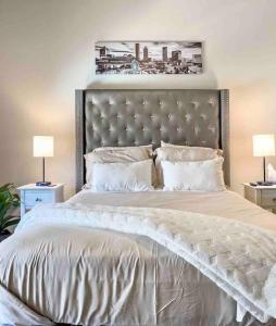 a bedroom with a large bed with a large headboard at Modern Midtown Oasis in Atlanta