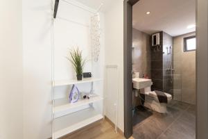 a bathroom with a shower and a sink and a toilet at Emporis Service Apartment By Sleepy Bear in Petaling Jaya