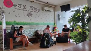 a group of people sitting in a waiting room at Kozy 15 Guesthouse in Surabaya