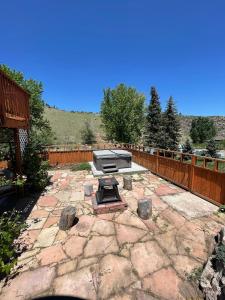 a backyard with a stone patio with a grill at ATTACHED MOTHER-IN-LAW SUITE Soak in the hot tub, star gaze, enjoy the reservoir, hike, bike, kayak and more - Private floor, entrance, terrace and room and bathroom, not the full house in Fort Collins
