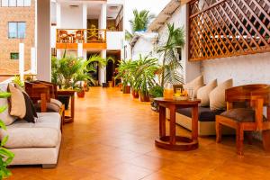 a lobby with couches and tables and plants at EXCLUSIVE CONDO GALAPAGOS and BEYOND 1 in Puerto Ayora