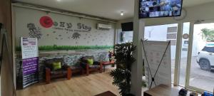 a store entrance with couches and a sign on the wall at Kozy 15 Guesthouse in Surabaya