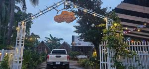 a white truck parked next to a white fence at Dak Nguyen Homestay DakLak in Dak Lak