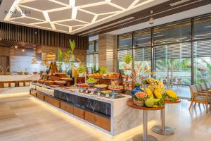 a restaurant with a buffet with food on display at Rosa Alba Resort & Villas Tuy Hoa in Tuy Hoa