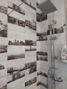 a bathroom with a shower with a tile wall at Ketchs House in Ponte de Sor +42 photos