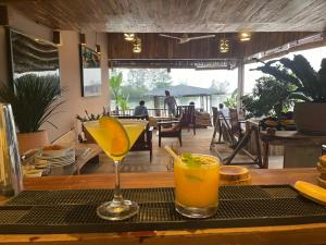 two cocktails sitting on a table in a restaurant at Eco Lagoon in Phú Quốc
