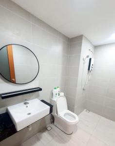 a bathroom with a sink and a toilet and a mirror at Lovely Studio 3 pax @Sky Condo Juru Sentral in Bukit Mertajam