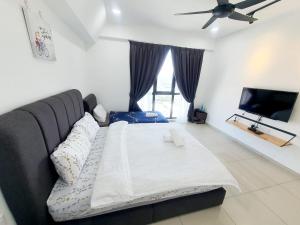 a living room with a large bed and a flat screen tv at Lovely Studio 3 pax @Sky Condo Juru Sentral in Bukit Mertajam