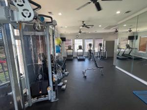 a gym with several treadmills and elliptical machines at New Listing!! Relax by the Beach!! 2 Queen Beds, 1 Sofa Couch, Free WiFi 2 TVs, Free Parking, Pool, Hot Tub, Gym , Elevator Accessible to property in Galveston