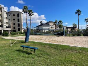 a park with an empty playground with a blue bench at New Listing!! Relax by the Beach!! 2 Queen Beds, 1 Sofa Couch, Free WiFi 2 TVs, Free Parking, Pool, Hot Tub, Gym , Elevator Accessible to property in Galveston