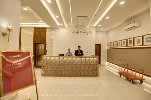 a man standing at a counter in a hospital lobby at Saltstayz Premier - Golf Course Extension Road in Gurgaon