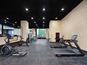 a gym with several treadmills and elliptical machines at Crowne Plaza Dujiangyan, an IHG Hotel in Dujiangyan