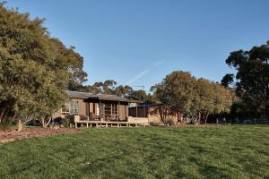 a house with a lawn in front of it at Ross Farm - Cabin in Meeniyan