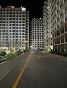 an empty street at night with two tall buildings at Saekyung village one phase 3 in Suba