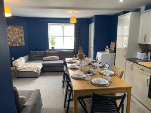 a kitchen and living room with a table and a couch at City living apartment no3 in Bristol