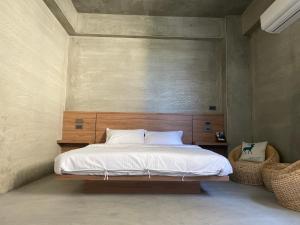 北埔鄉的住宿－沐目家 Xiang Jia Homestay，一间卧室配有一张大床和木制床头板